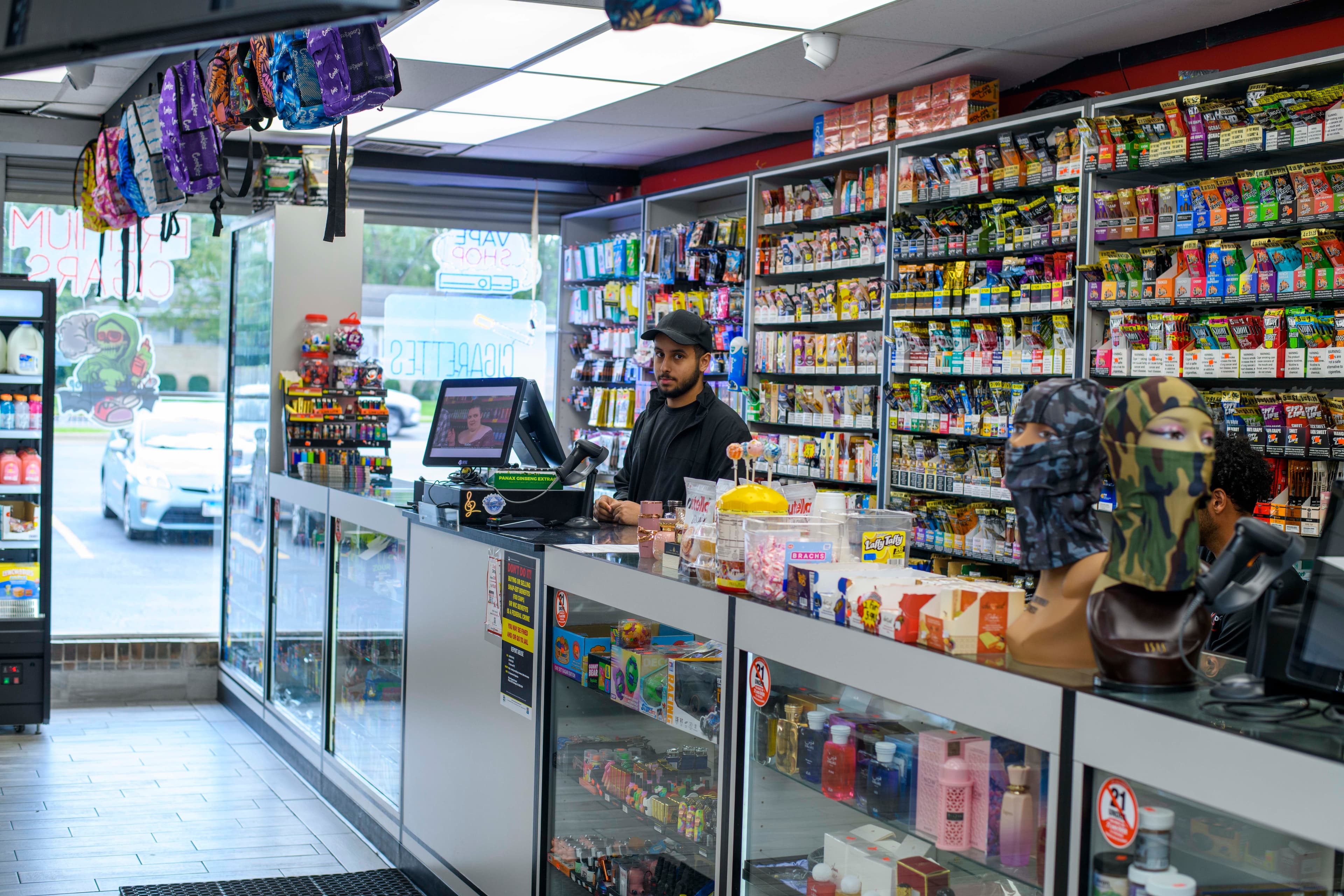 Store staff behind the checkout counter